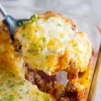 Puffed Up Pizza Casserole being scooped out.