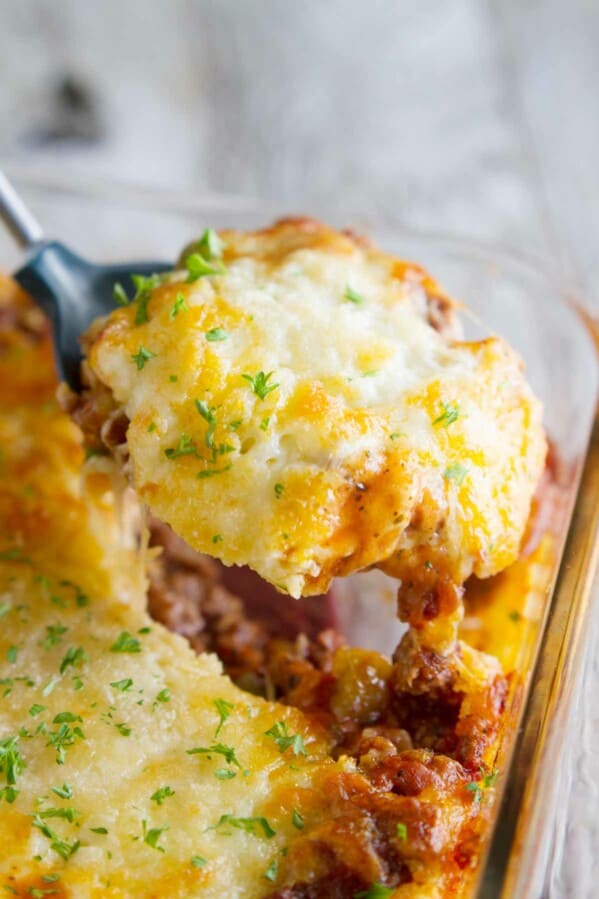 Puffed Up Pizza Casserole being scooped out.