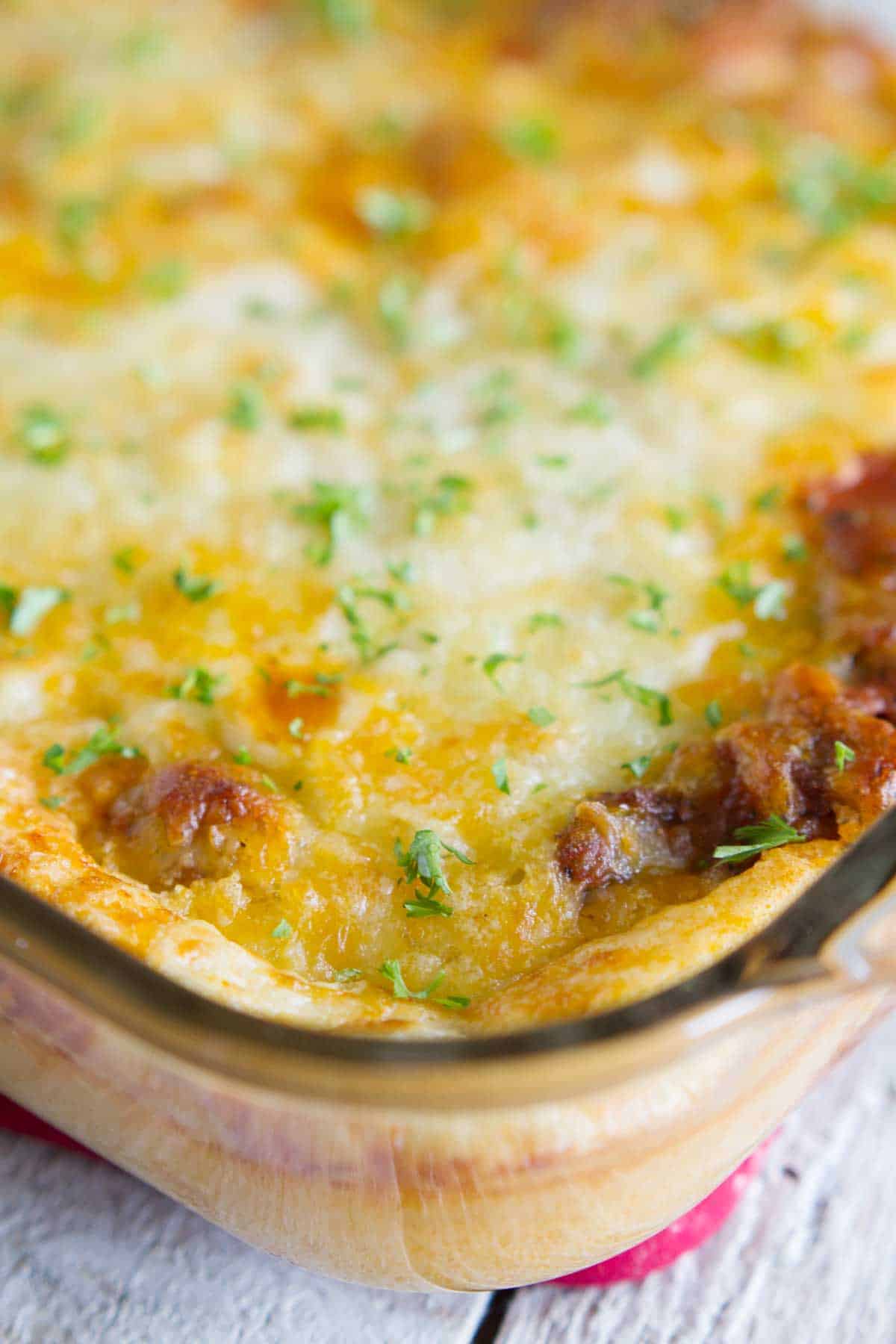 Puffed Up Pizza Casserole in a glass casserole dish.
