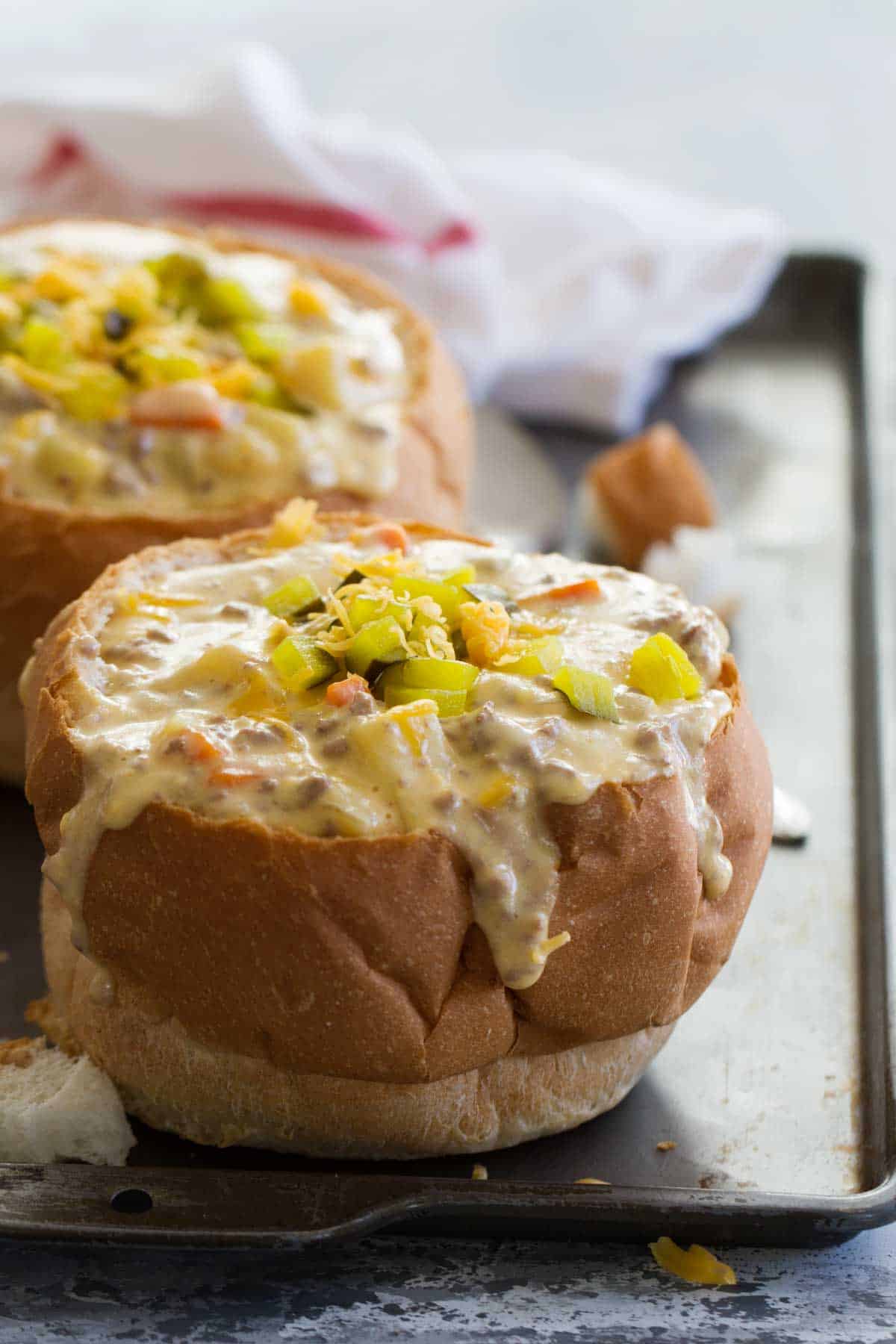 All of the flavors of your favorite cheeseburgers, but in a fantastic slow cooker soup, this Crock Pot Cheeseburger Soup is filled with ground beef and lots of veggies all in a creamy, cheesy soup. Crock Pot Cheeseburger Soup in a Bread Bowl