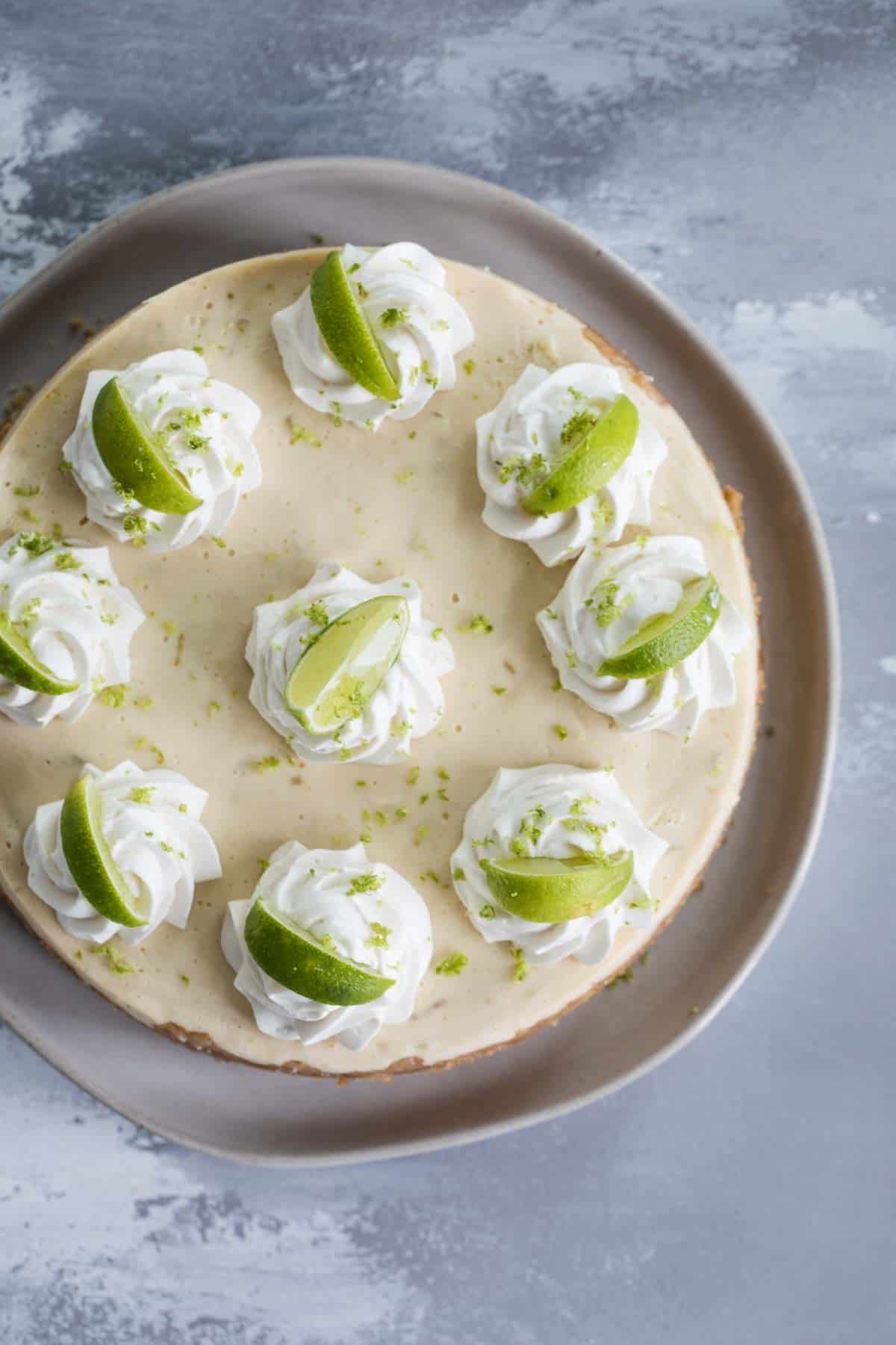 Pressure Cooker Cheesecake - Key Lime topped with whipped cream and limes.