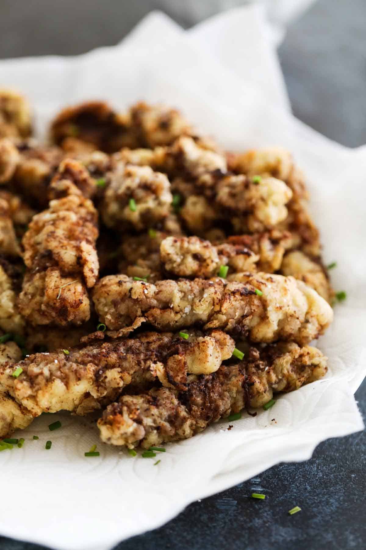 Chicken Fried Steak Fingers sprinkled with herbs.