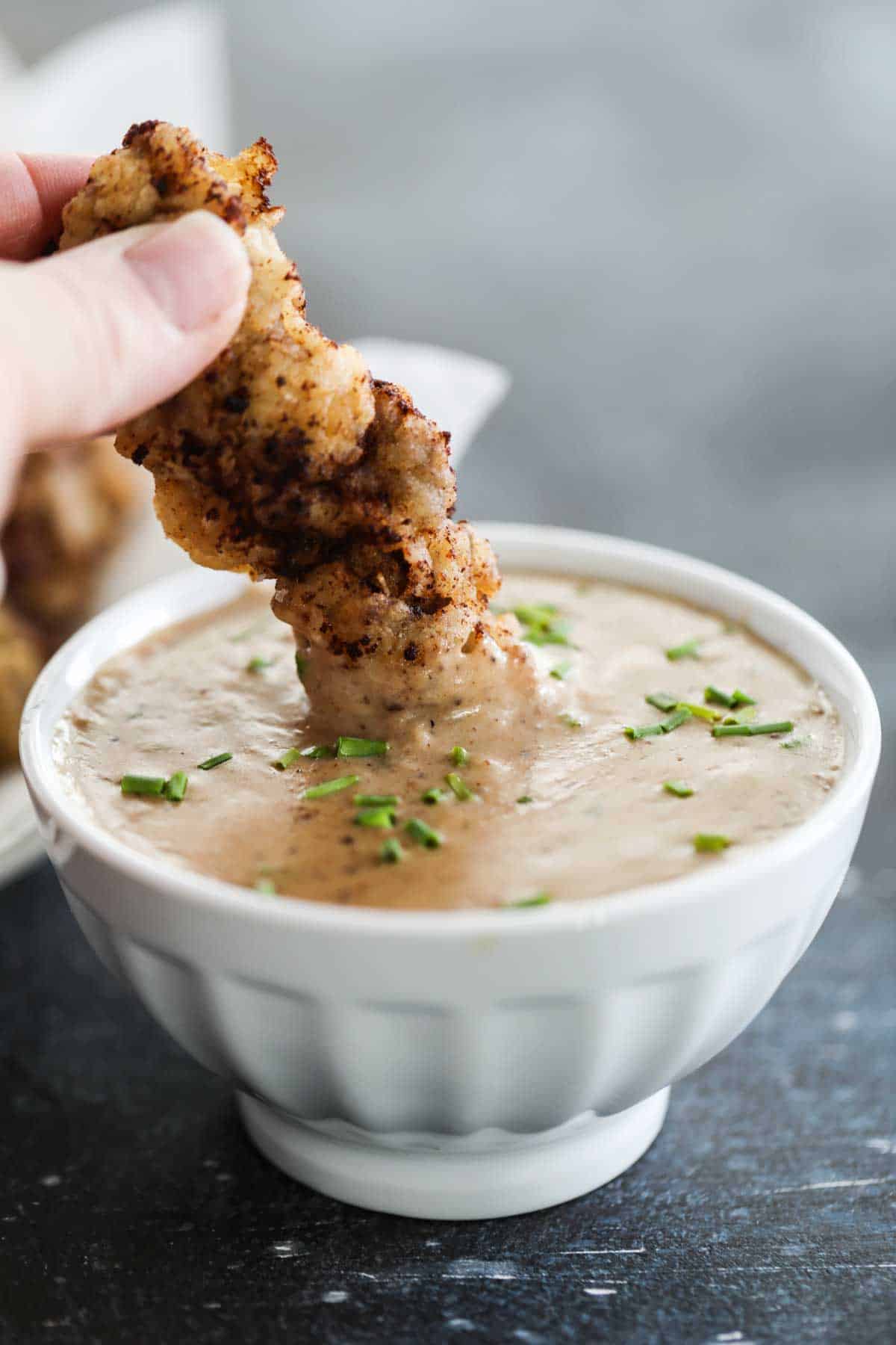 Dipping Chicken Fried Steak Fingers into gravy.