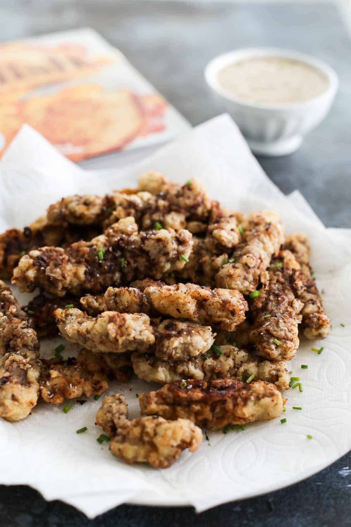 Chicken Fried Steak Fingers on a paper lined plate.