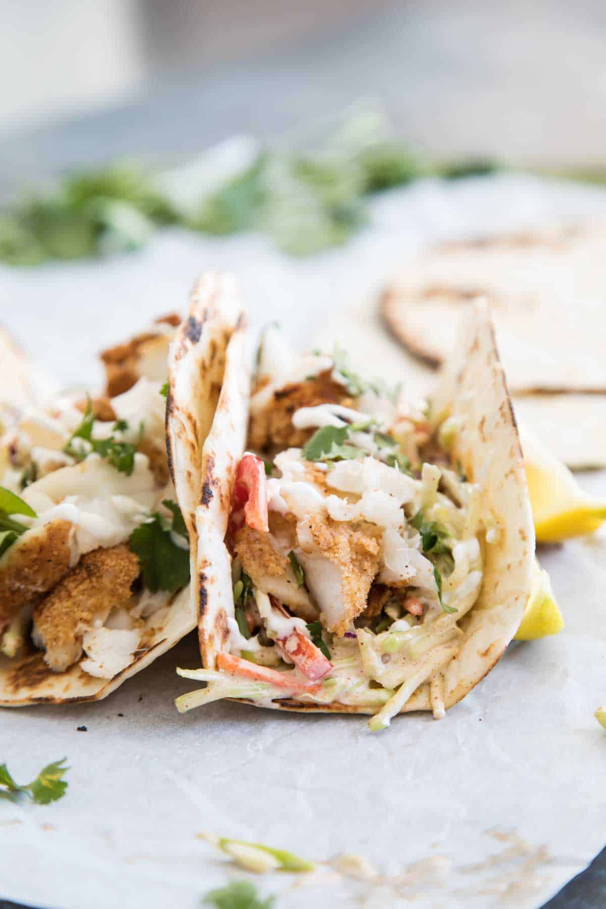 Fish tacos with cajun seasoning on flour tortillas.