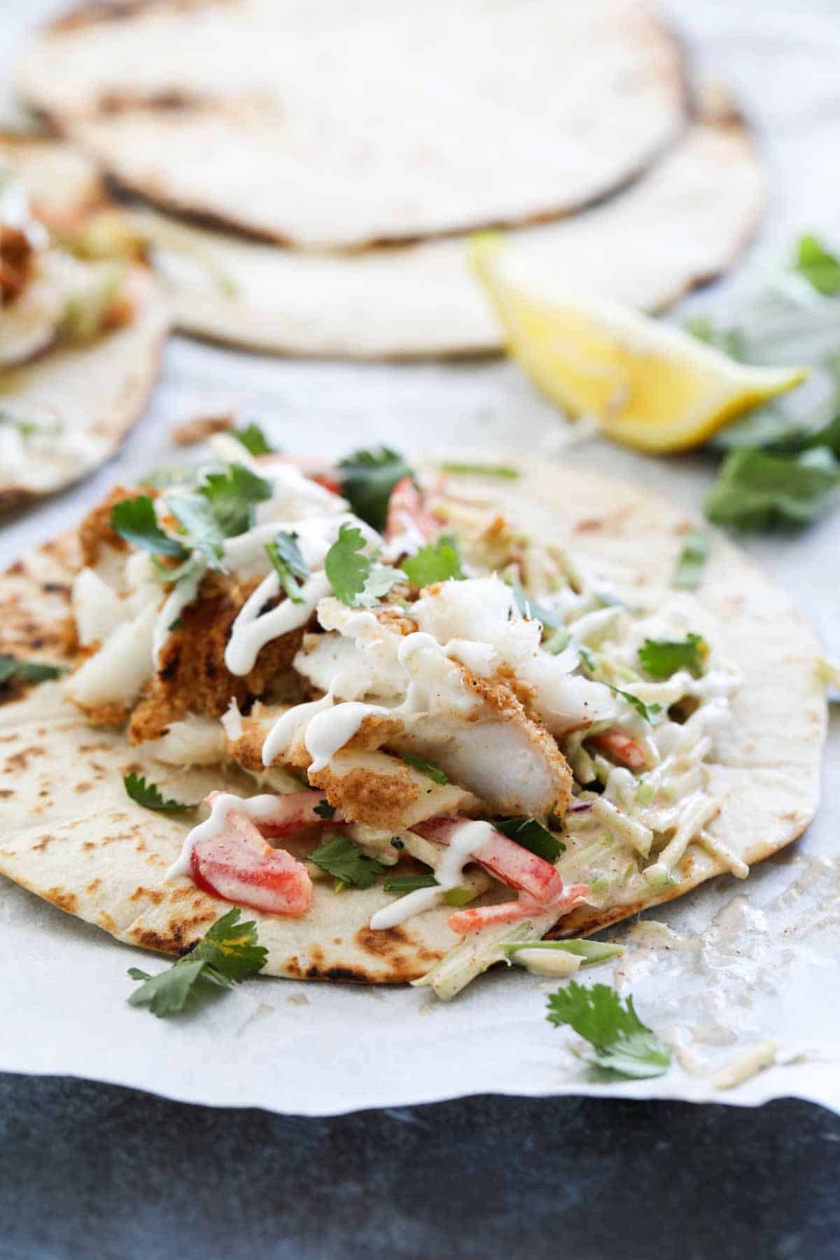 Flour tortillas topped with cajun spiced fish.