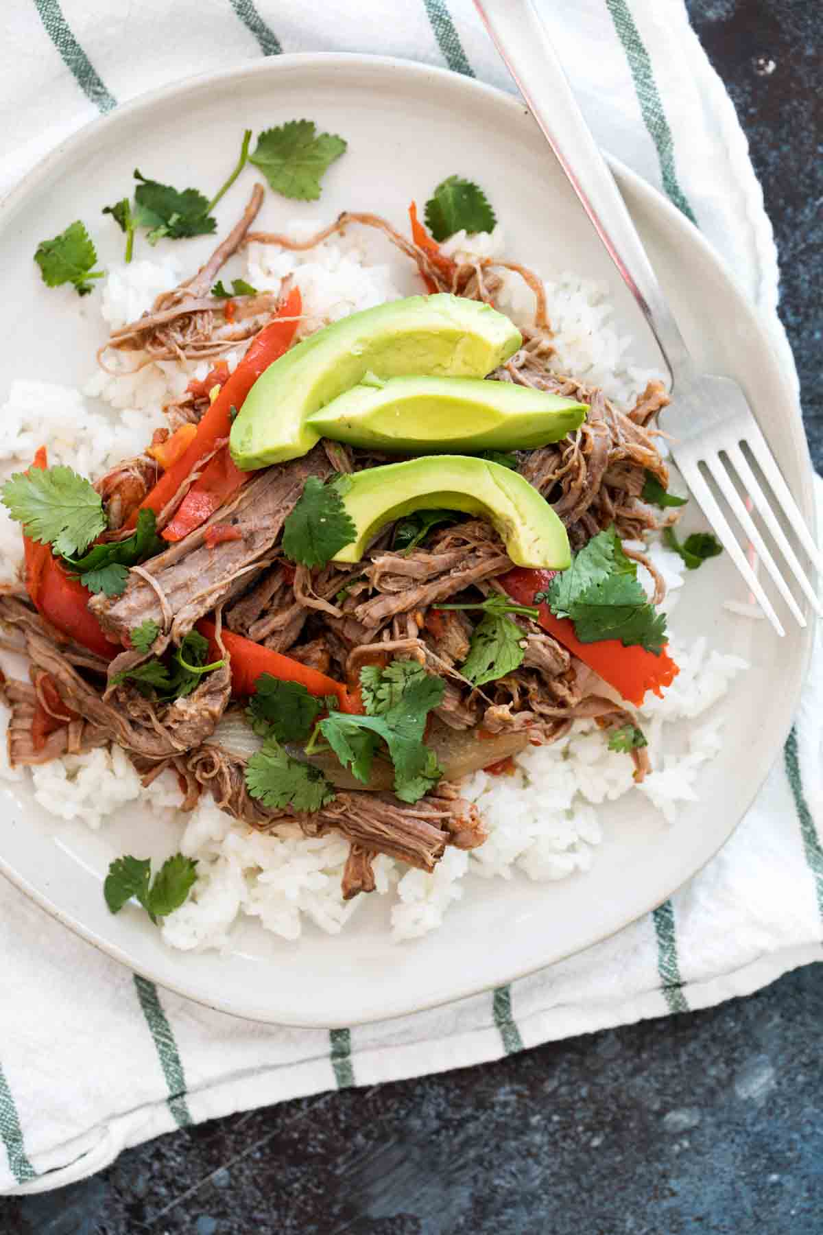 Slow Cooker Cuban Ropa Vieja served over rice.