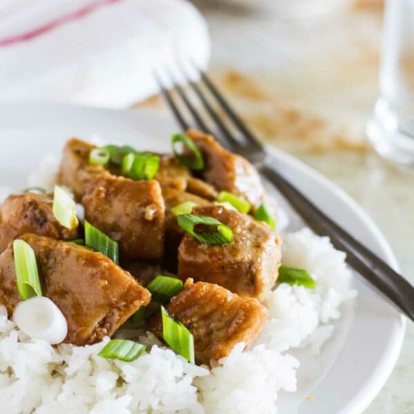 Asian Slow Cooker Pork Roast over rice on a plate.