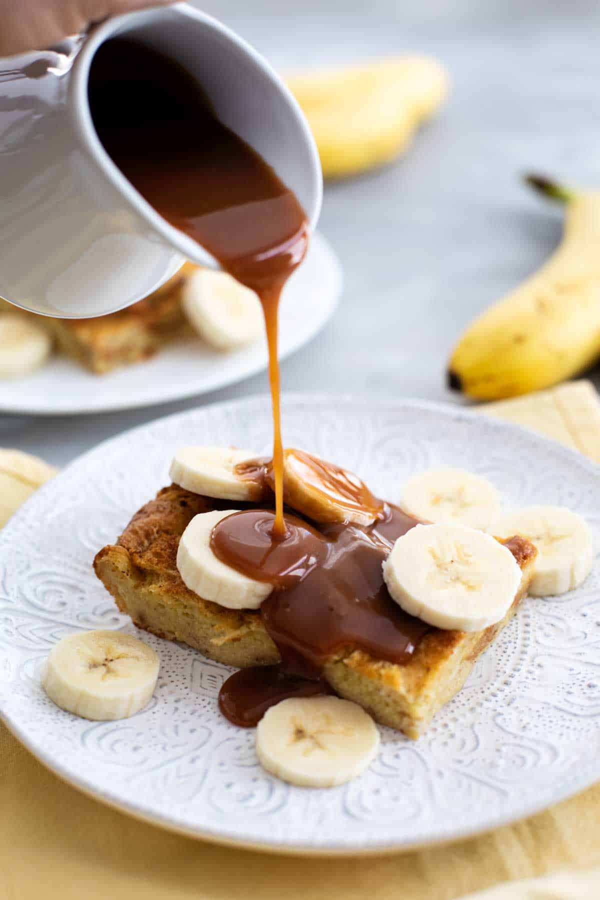 Brioche French Toast Recipe with Homemade Salted Caramel being poured over the top.