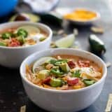 bowl of creamy chicken tortilla soup with lots of toppings