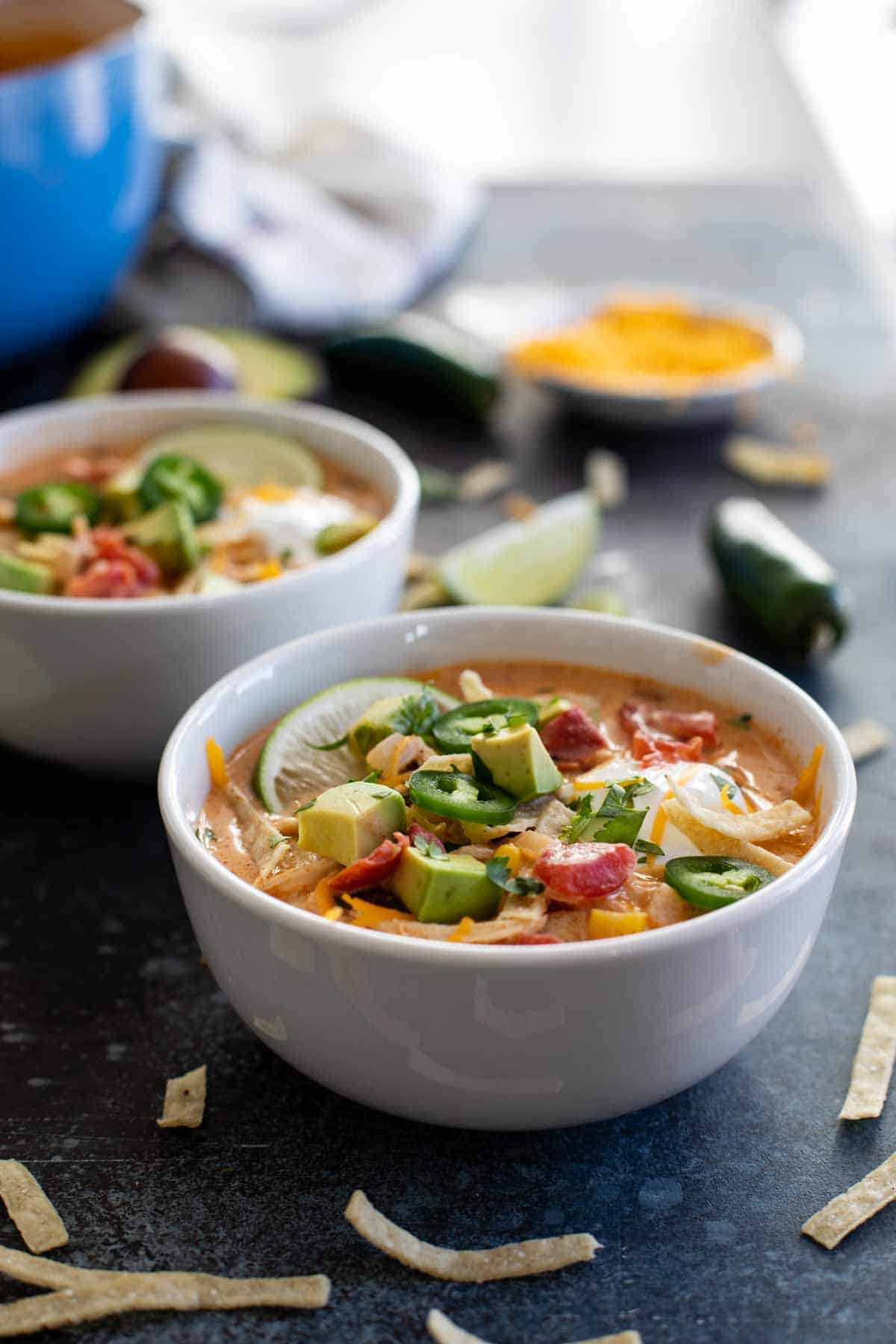 bowl of creamy chicken tortilla soup with lots of toppings