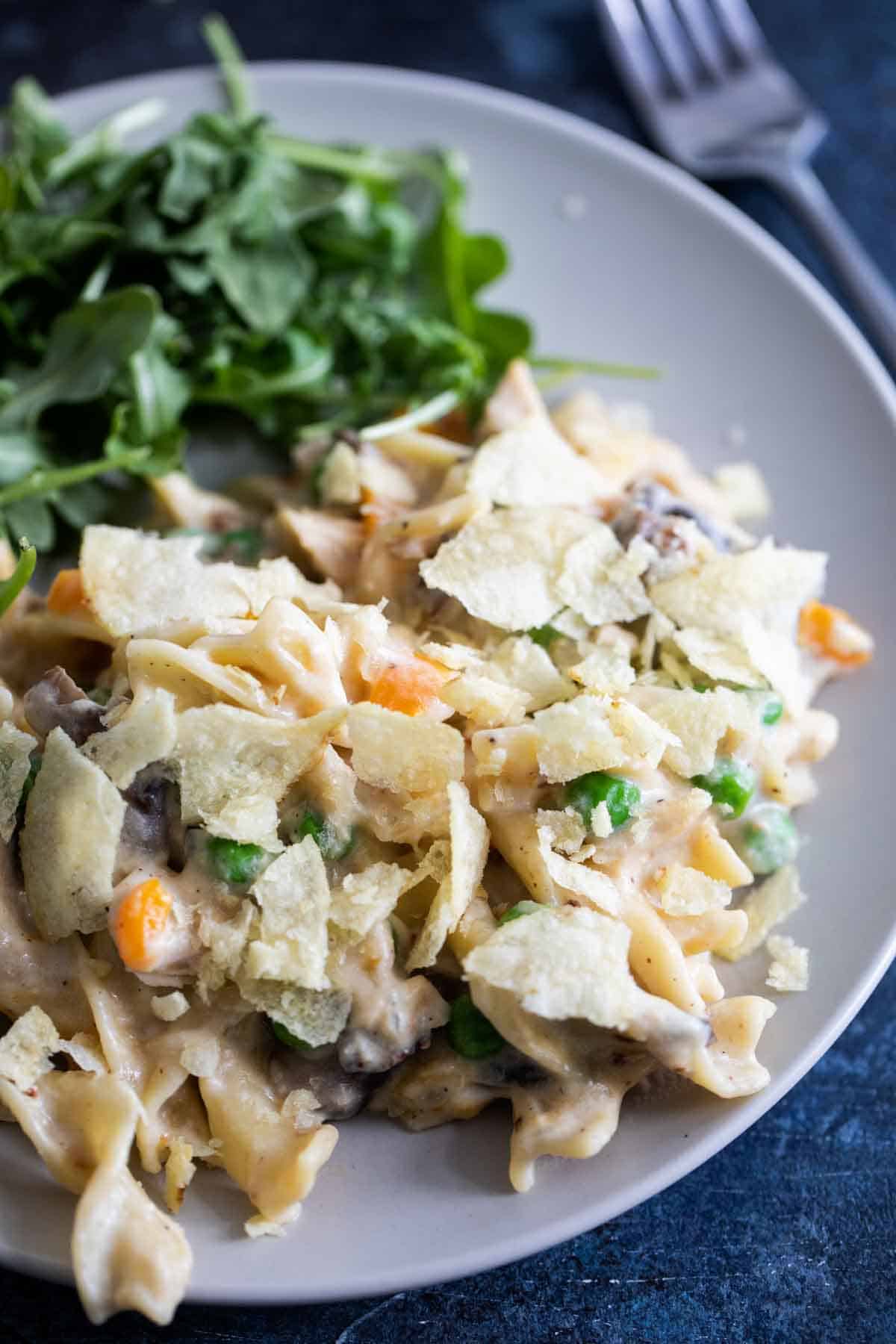 Best Tuna Noodle Casserole on a plate, topped with crushed potato chips.