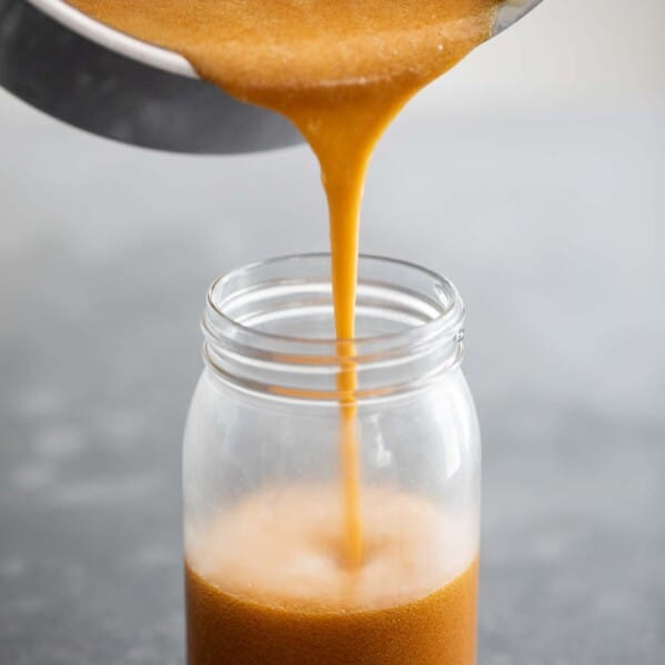 Pouring buttermilk syrup into a jar.