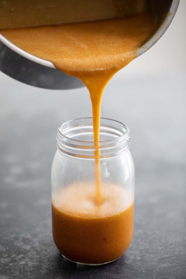 Pouring buttermilk syrup into a jar.