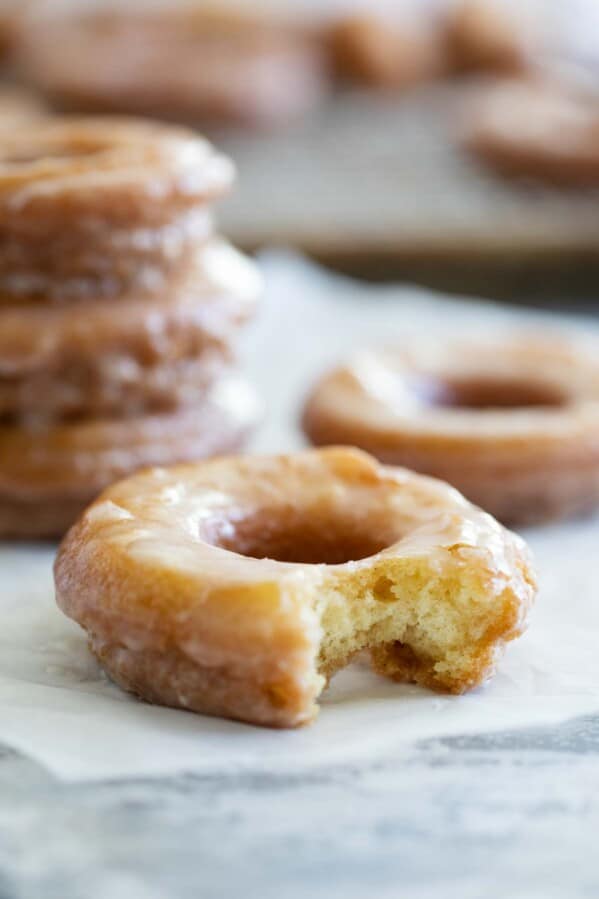 Glazed Cake Donut with a bite taken from it.