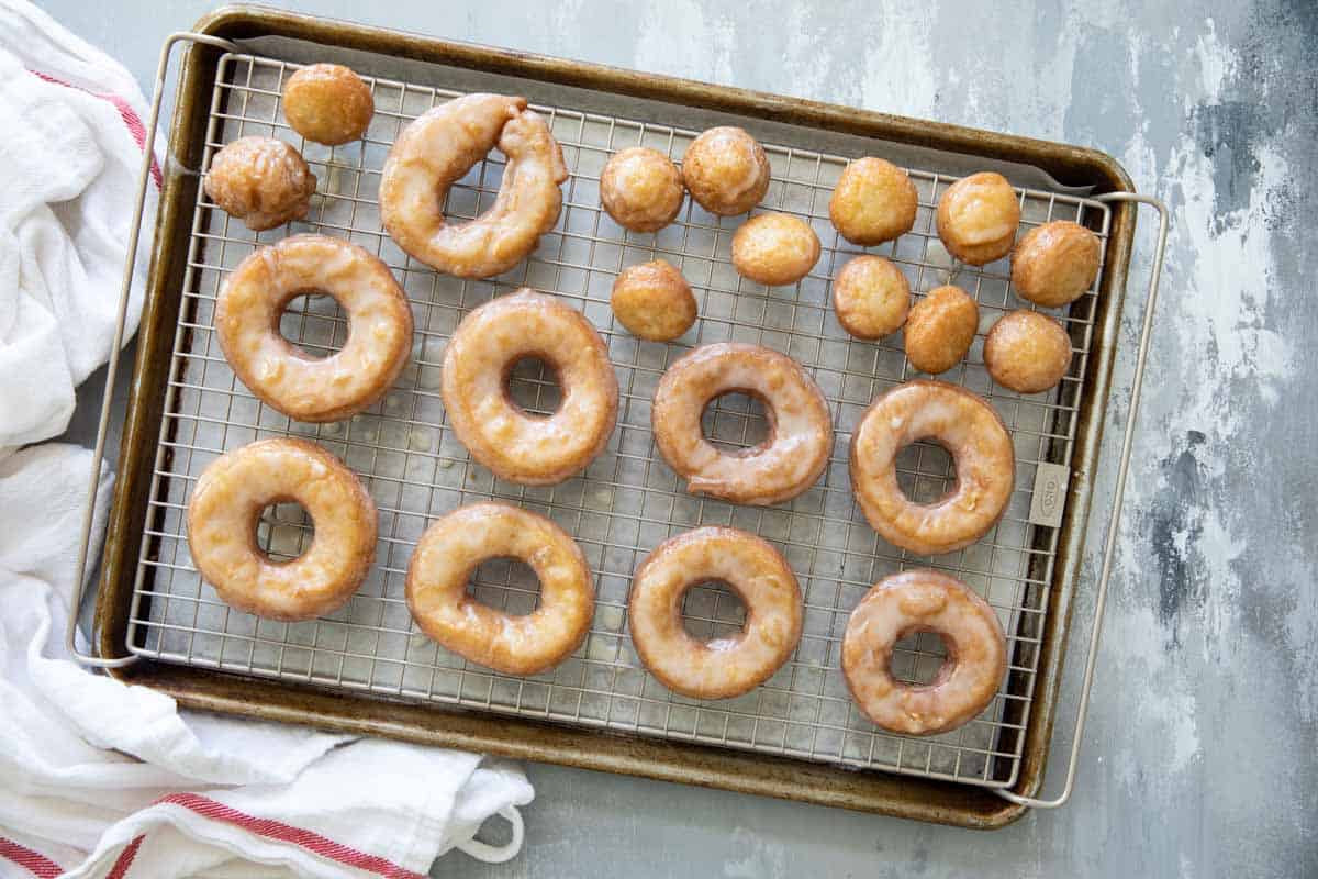 Glazed Cake Donuts on a cooling rack.