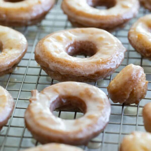 Homemade Cake Donuts with a glaze over a cooling rack.