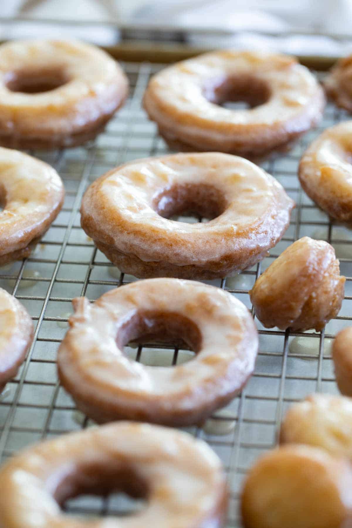 Homemade Cake Donuts with a glaze over a cooling rack.