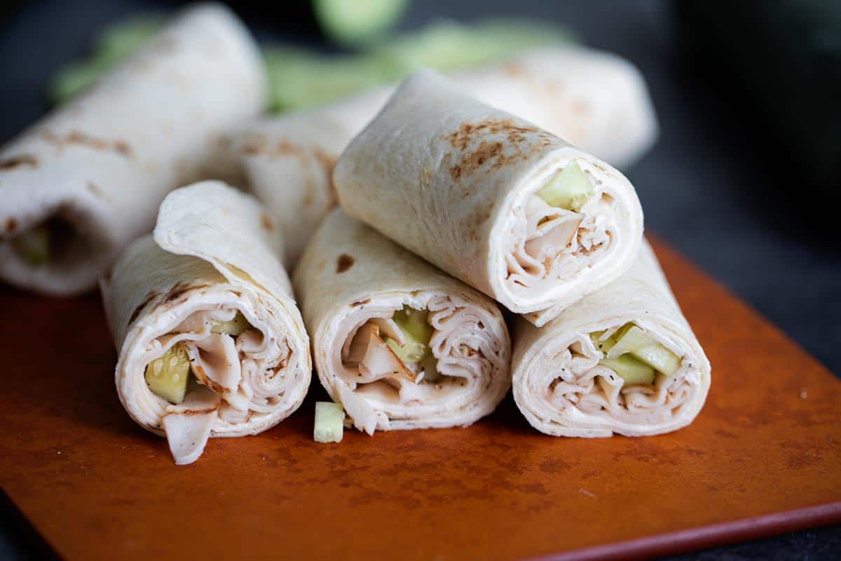 Cucumber Ranch Turkey Tortilla Wraps cut in half and stacked on each other.