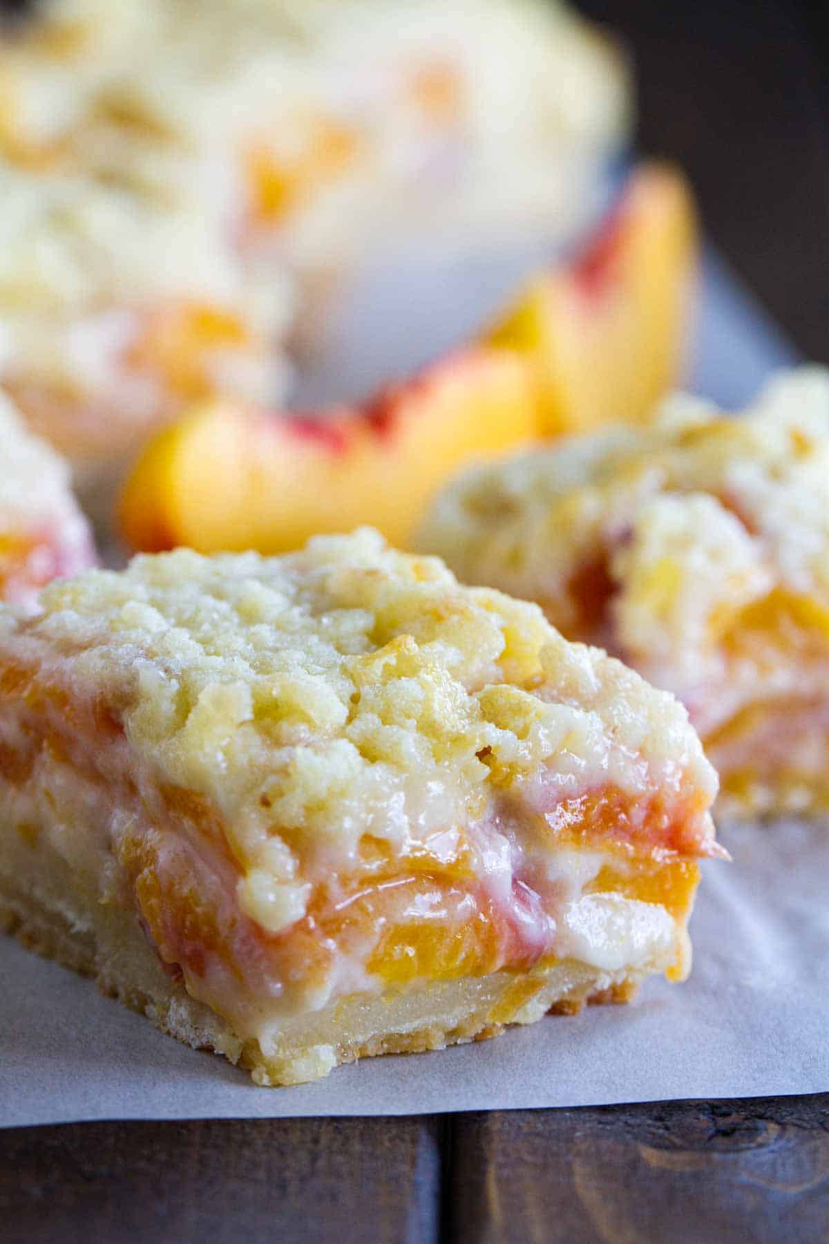 For a different take on a peach pie, try these Peaches and Cream Bars that have a shortbread crust, a creamy peach filling and a crumble topping. peaches and cream bar wirth crumble topping