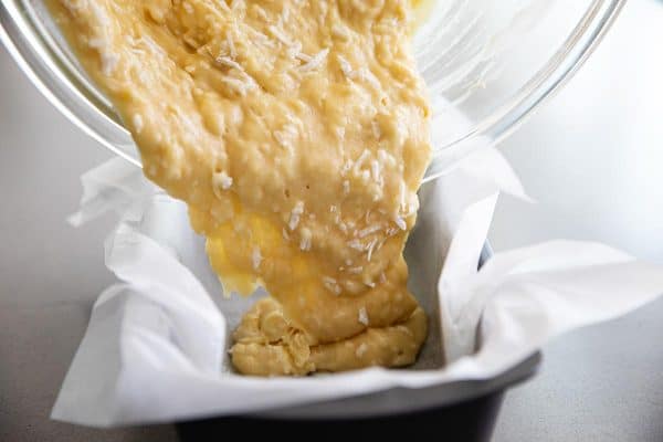 pouring batter in a loaf pan