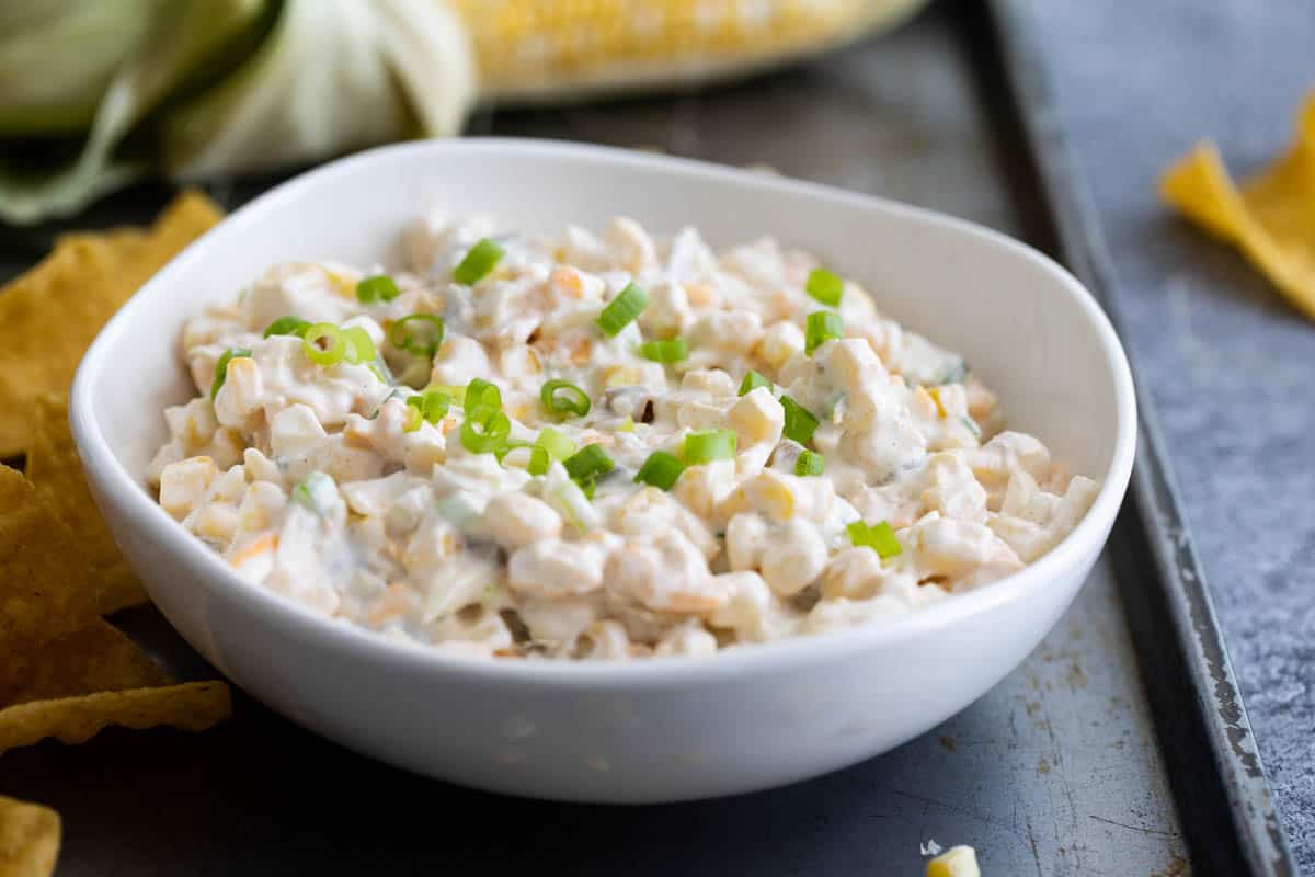 Corn Dip with Green Chiles in a bowl on a baking sheet