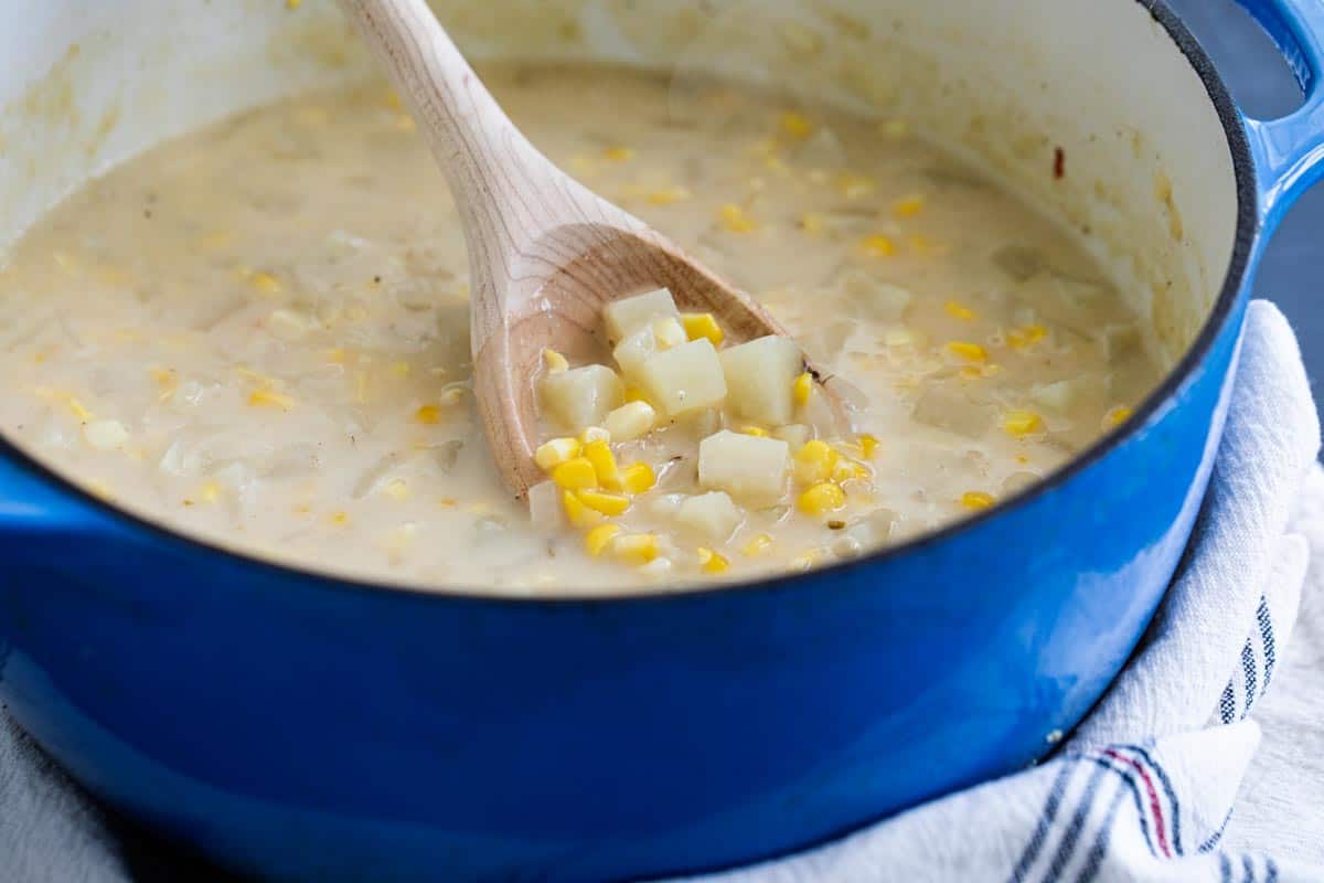 A perfect way to use up bountiful fresh corn, this Potato Corn Chowder is the perfect end of summer soup. Or freeze extra grilled corn for a delicious soup all winter long. chowder made with potatoes and corn in a dutch oven