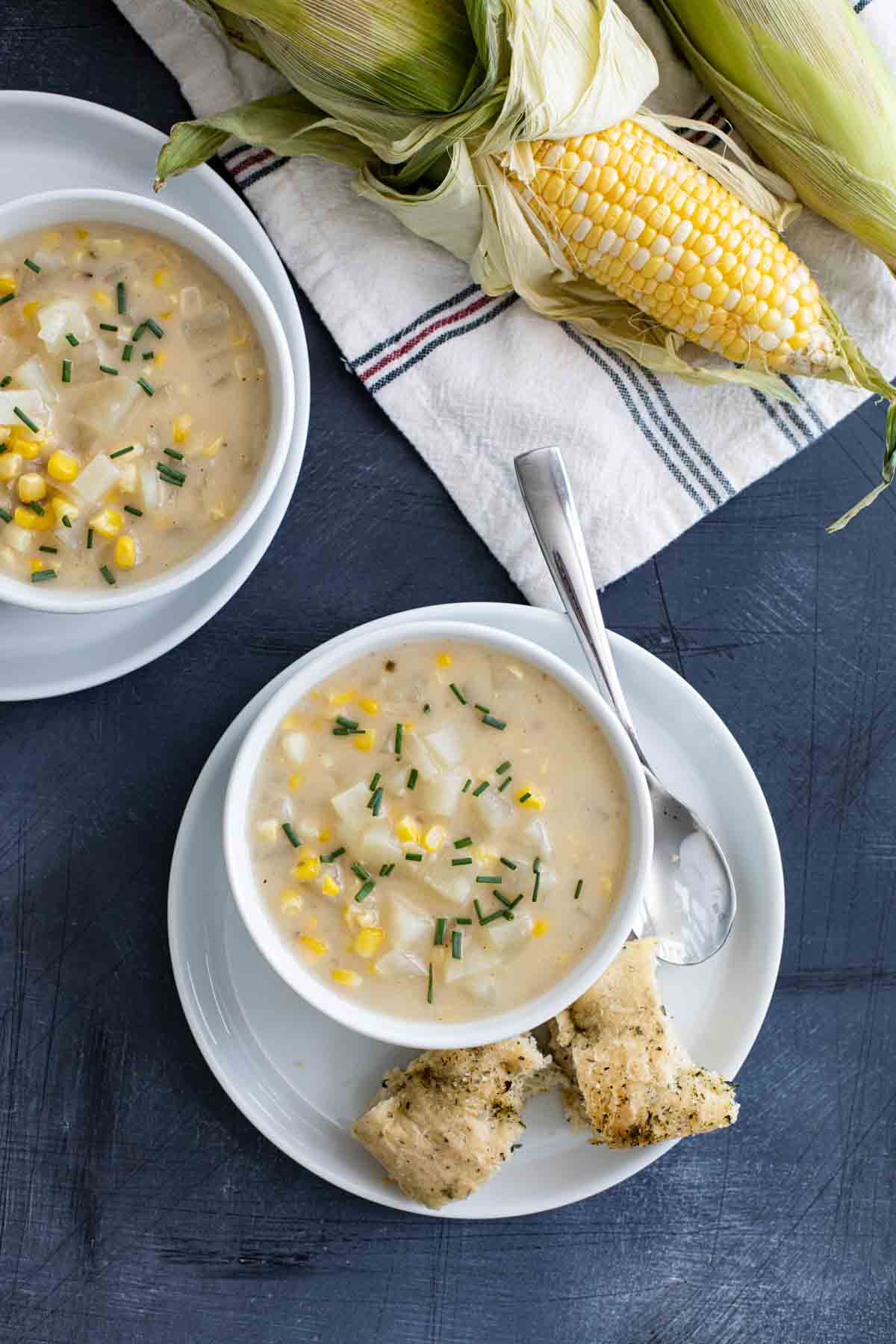 A perfect way to use up bountiful fresh corn, this Potato Corn Chowder is the perfect end of summer soup. Or freeze extra grilled corn for a delicious soup all winter long. bowls of Potato Corn Chowder