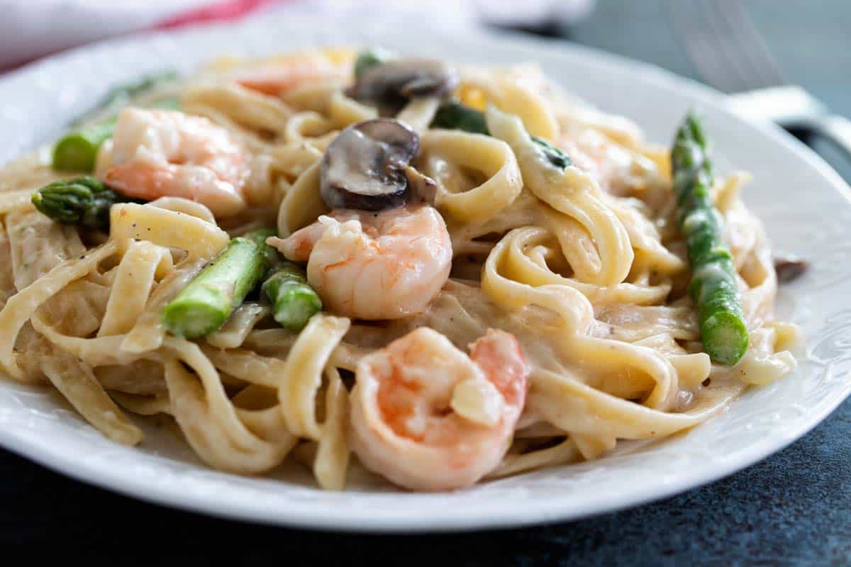 Shrimp Alfredo - pasta with white sauce, shrimp and asparagus.