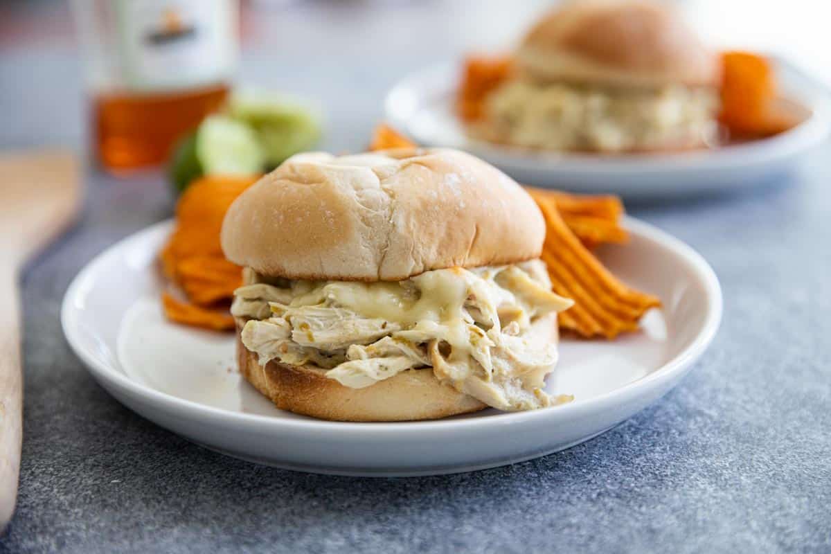 Pulled chicken sandwiches with a Mexican and Swiss twist! These Suizas Style Pulled Chicken Sandwiches are made easy with shredded chicken, making this a 20 minute dinner recipe. Easy Suizas Style Pulled Chicken Sandwiches