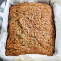 loaf of baked zucchini bread in a loaf pan