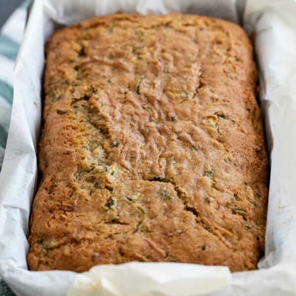 loaf of baked zucchini bread in a loaf pan