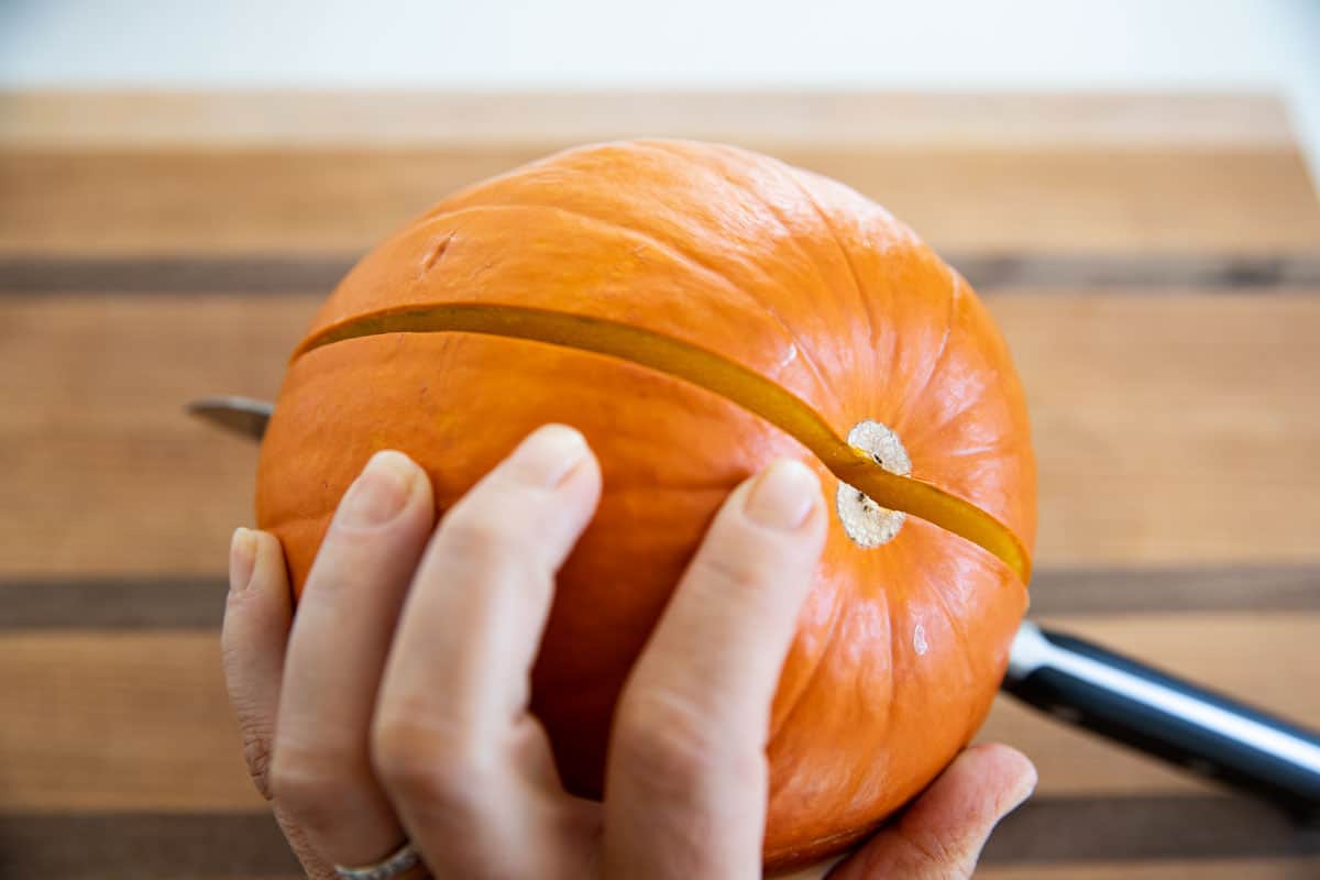 Cutting a sugar pumpkin in half