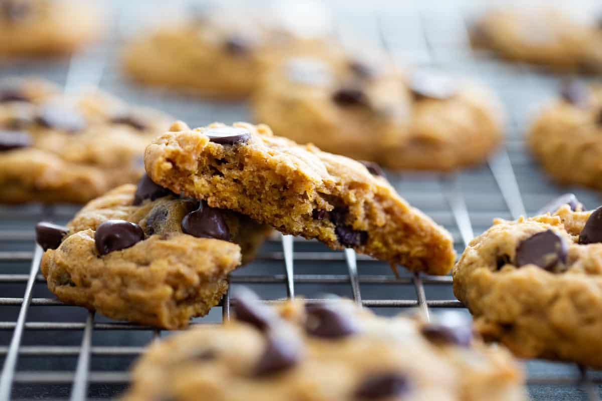 Oatmeal Pumpkin Chocolate Chip Cookie broken in half to show inside of cookie.