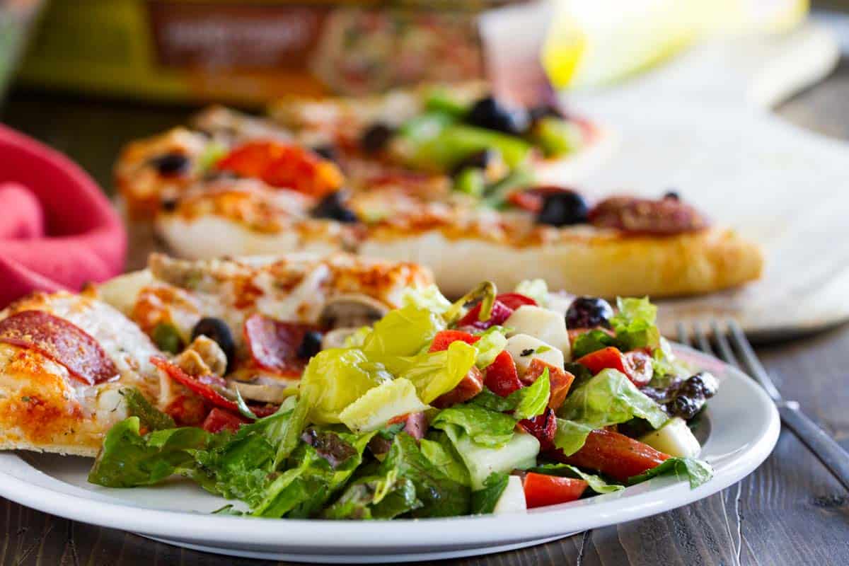 plate with pizza and Antipasto Salad