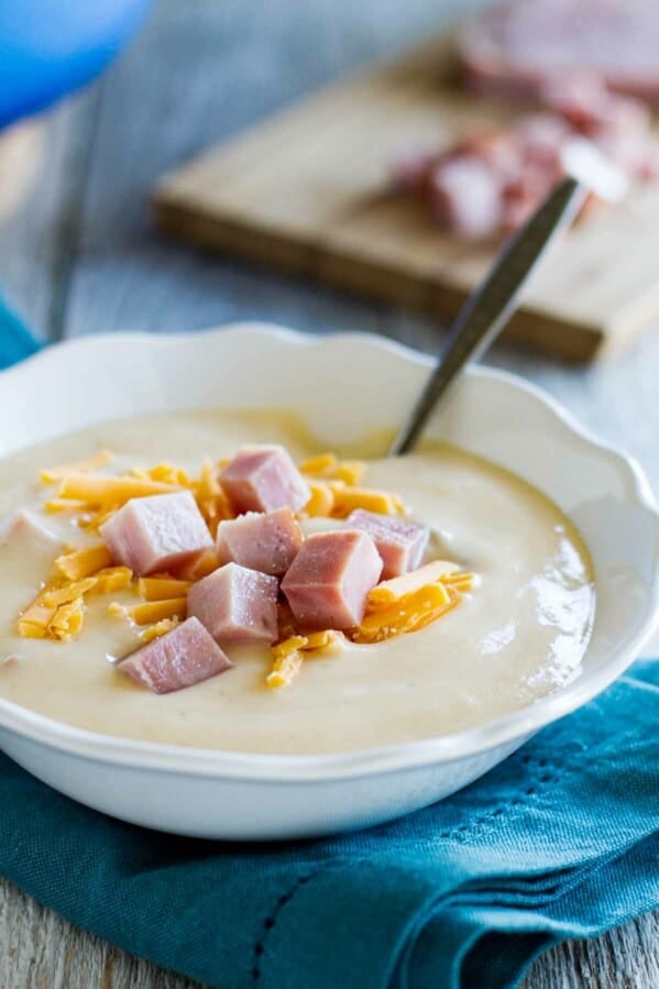 bowl of cauliflower soup topped with ham and cheese