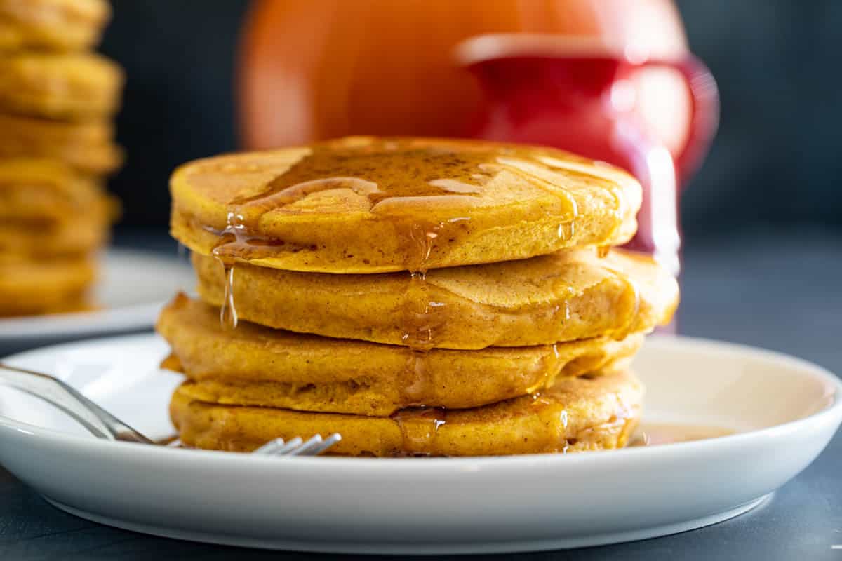 Stack of pumpkin pancakes with syrup