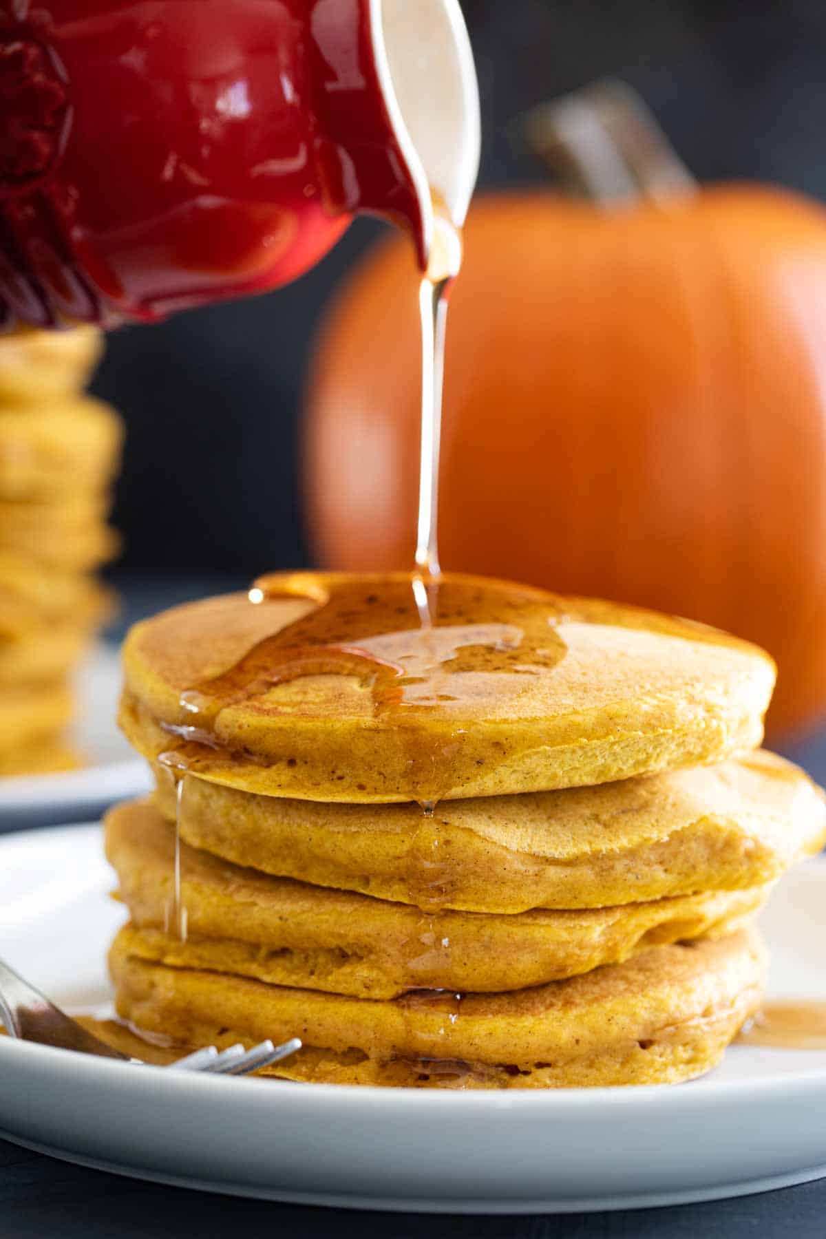 pouring syrup on pancakes