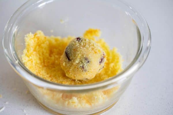 rolling cookie dough in orange sugar