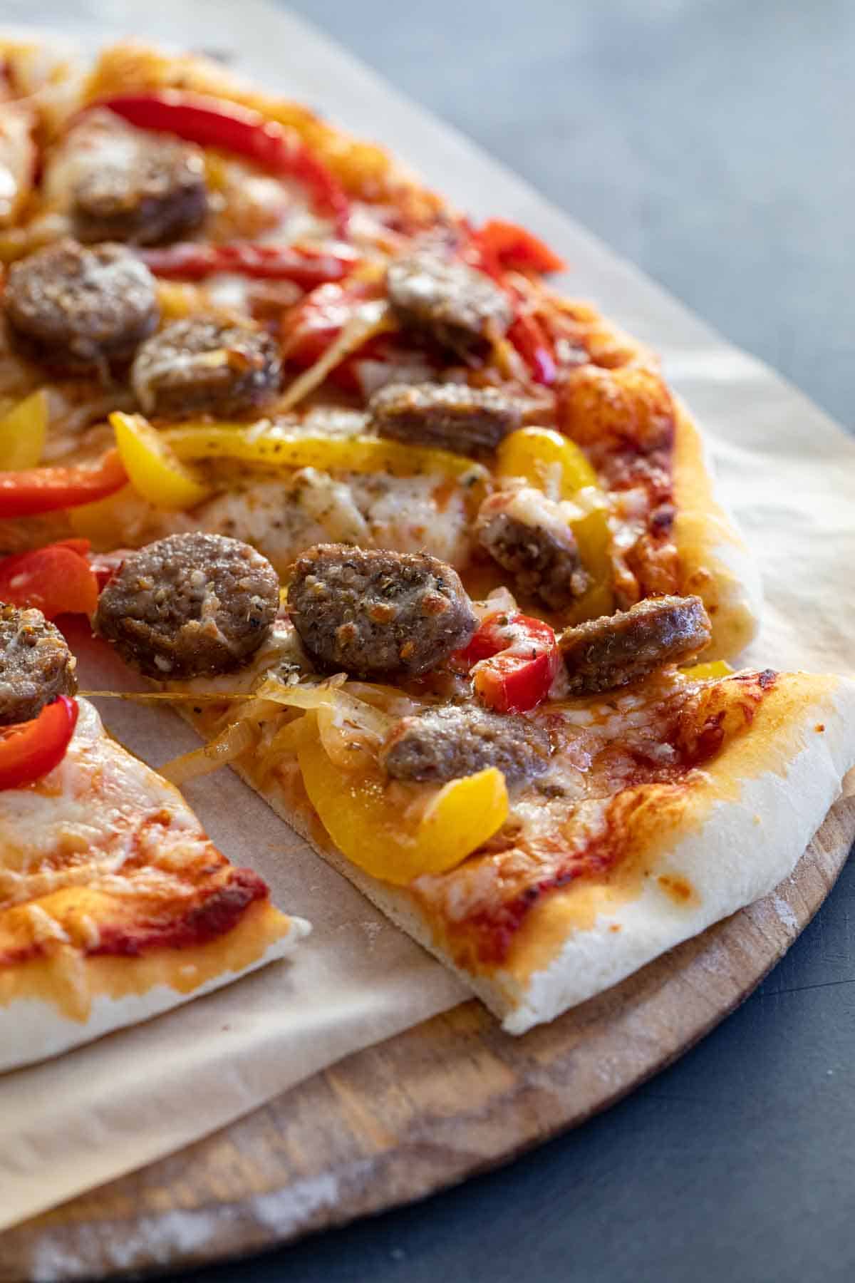 slice of pizza with sausage and peppers