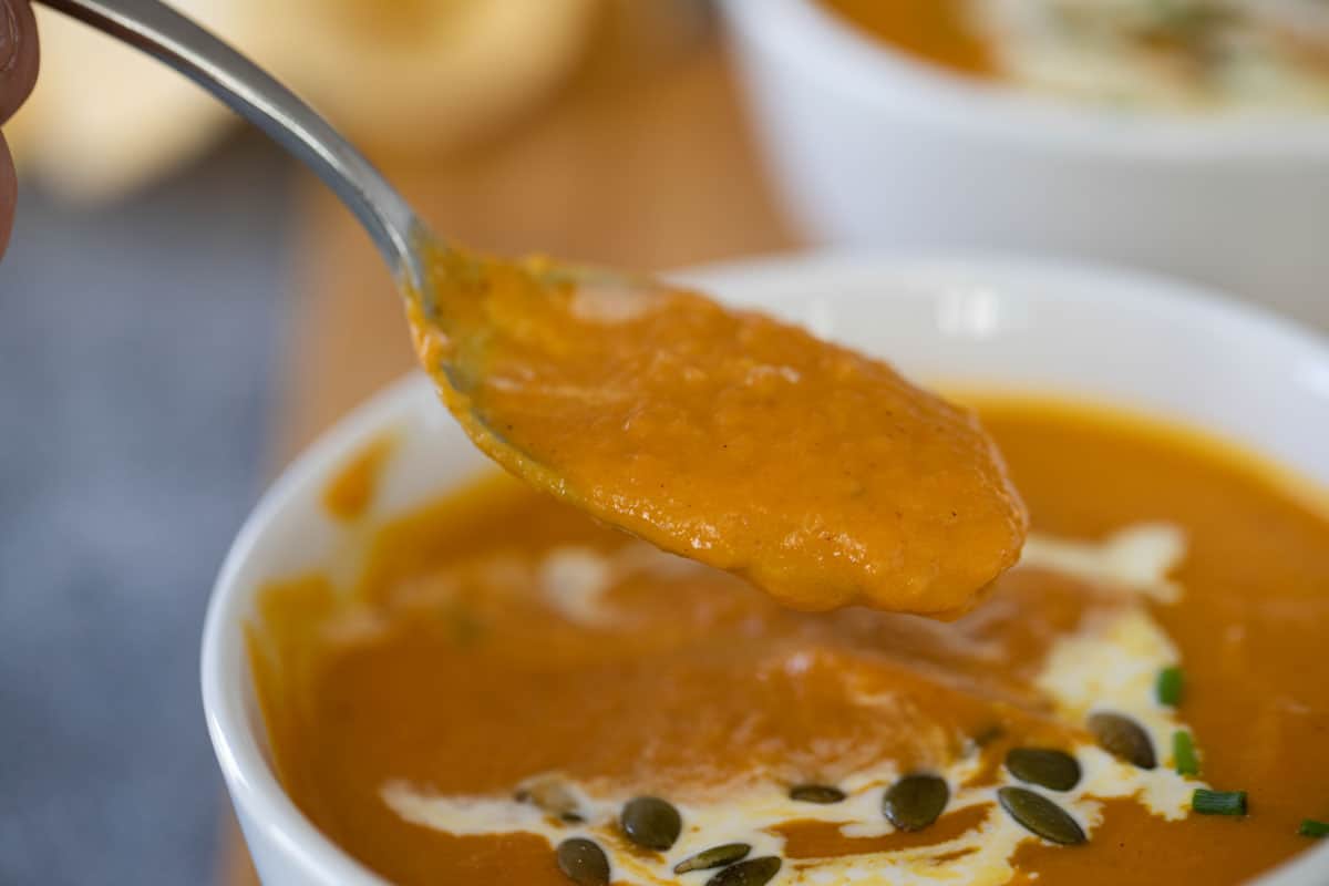 spoonful of pumpkin soup showing texture of the soup