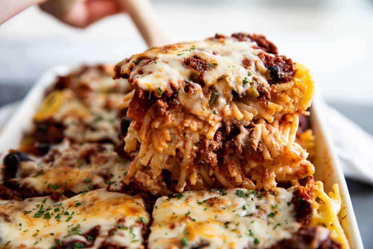 Comforting and delicious, this Baked Spaghetti is perfect for potlucks or Sunday dinner. Spaghetti noodles are combined with a meaty sauce and lots of cheese and baked to perfection. Baked Spaghetti with Meat Sauce