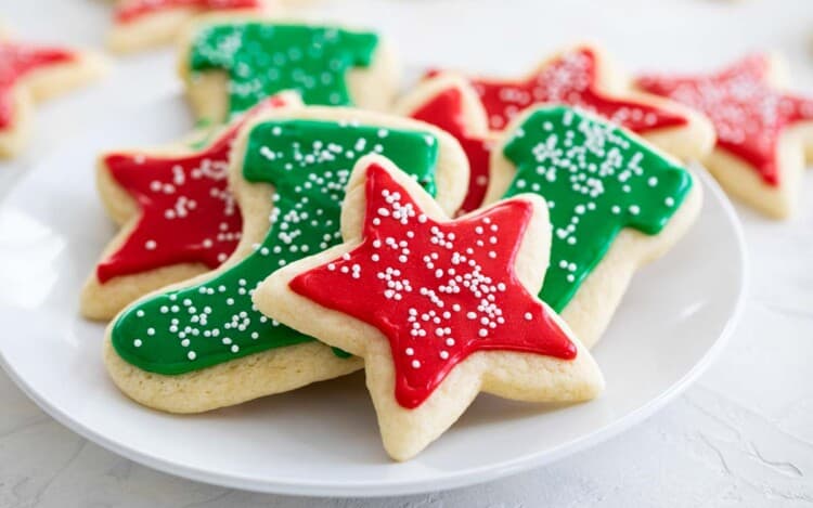 sugar cookies on a plate with red and green sugar cookie icing