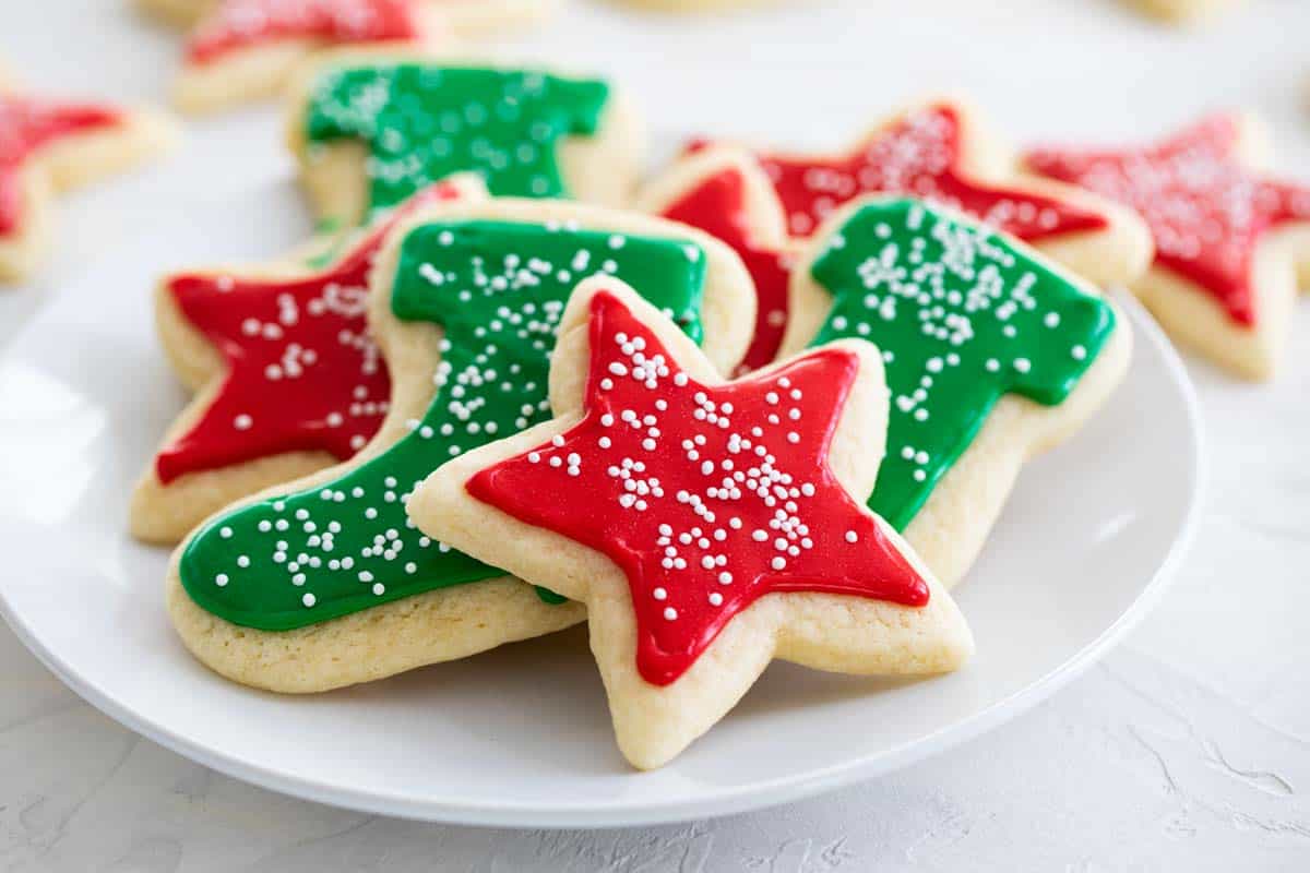 sugar cookies on a plate with red and green sugar cookie icing