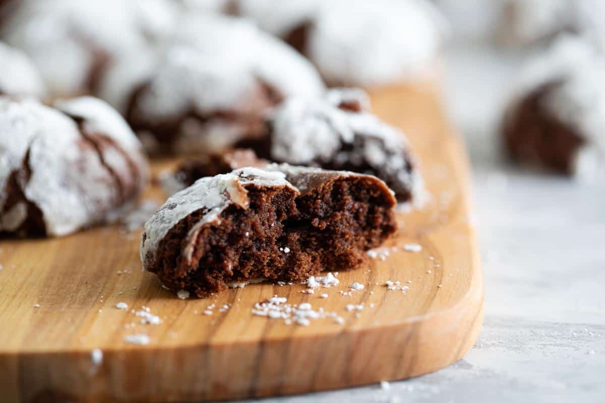 chocolate crinkle cookie broken in half to show texture of the middle of the cookie.