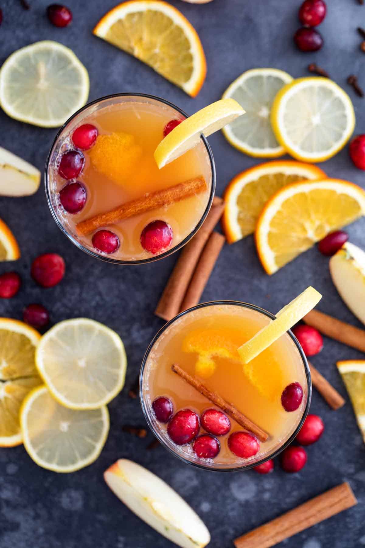 Hot Apple Cider made with citrus and apple, topped with cinnamon sticks and cranberries.