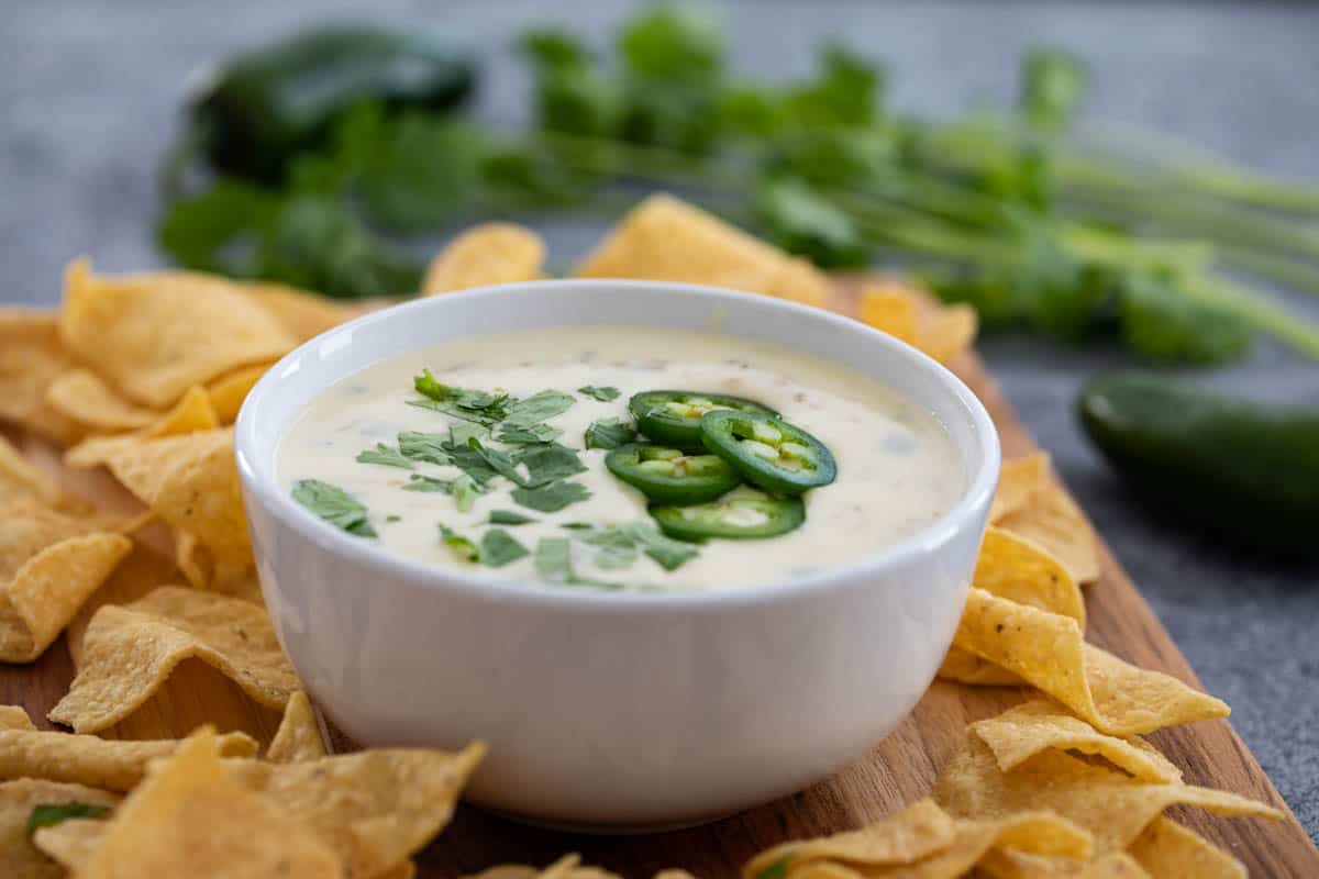 bowl of white queso blanco surrounded by tortilla chips