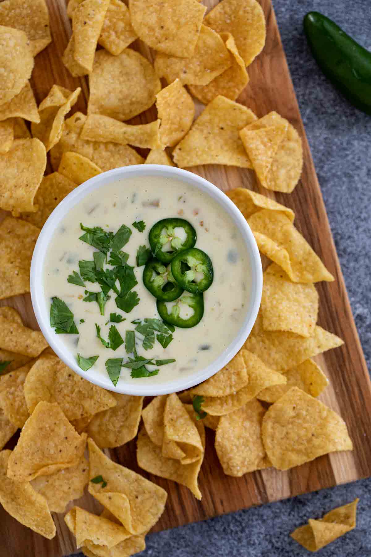 overhead view of queso blanco with jalapenos and tortilla chips