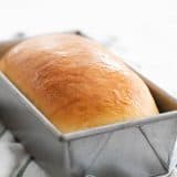 loaf of homemade white bread in a pan