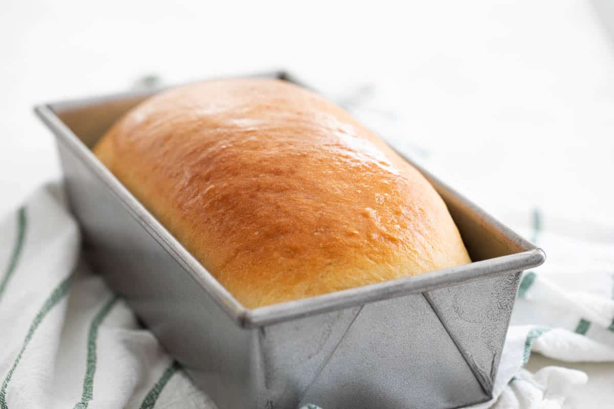 loaf of homemade white bread in a pan